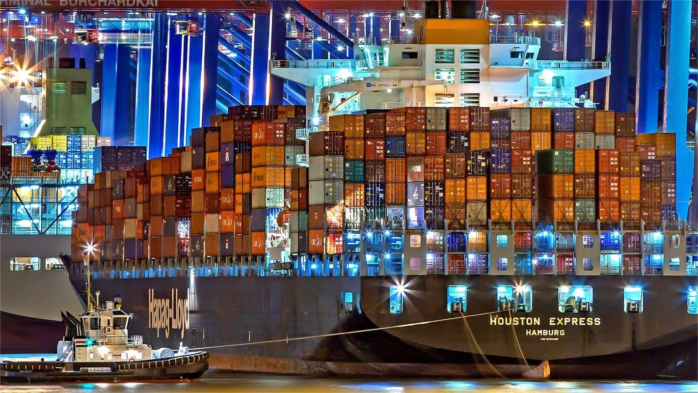 Cargo ship loaded with containers sailing across the ocean